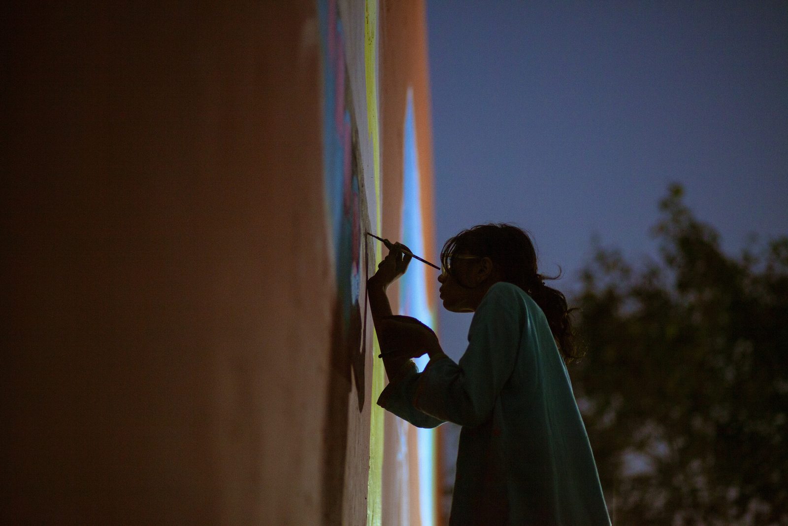 Mural being painted at dusk
