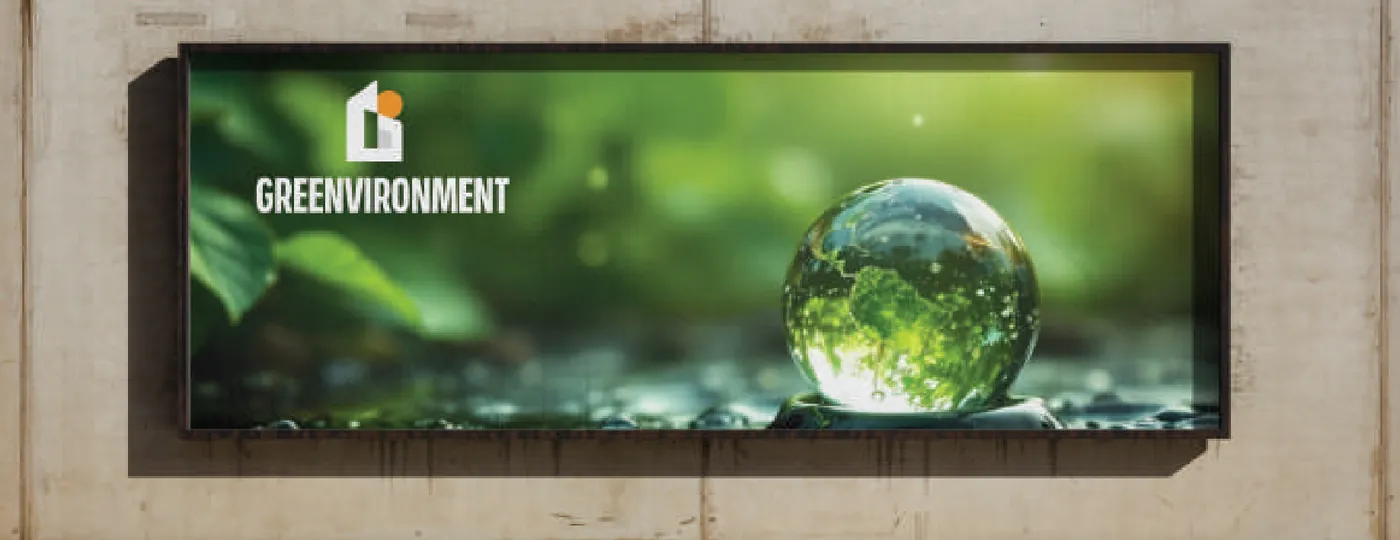 Greenvironment hoarding — a seedling held in a droplet of water, with the wordmark set left